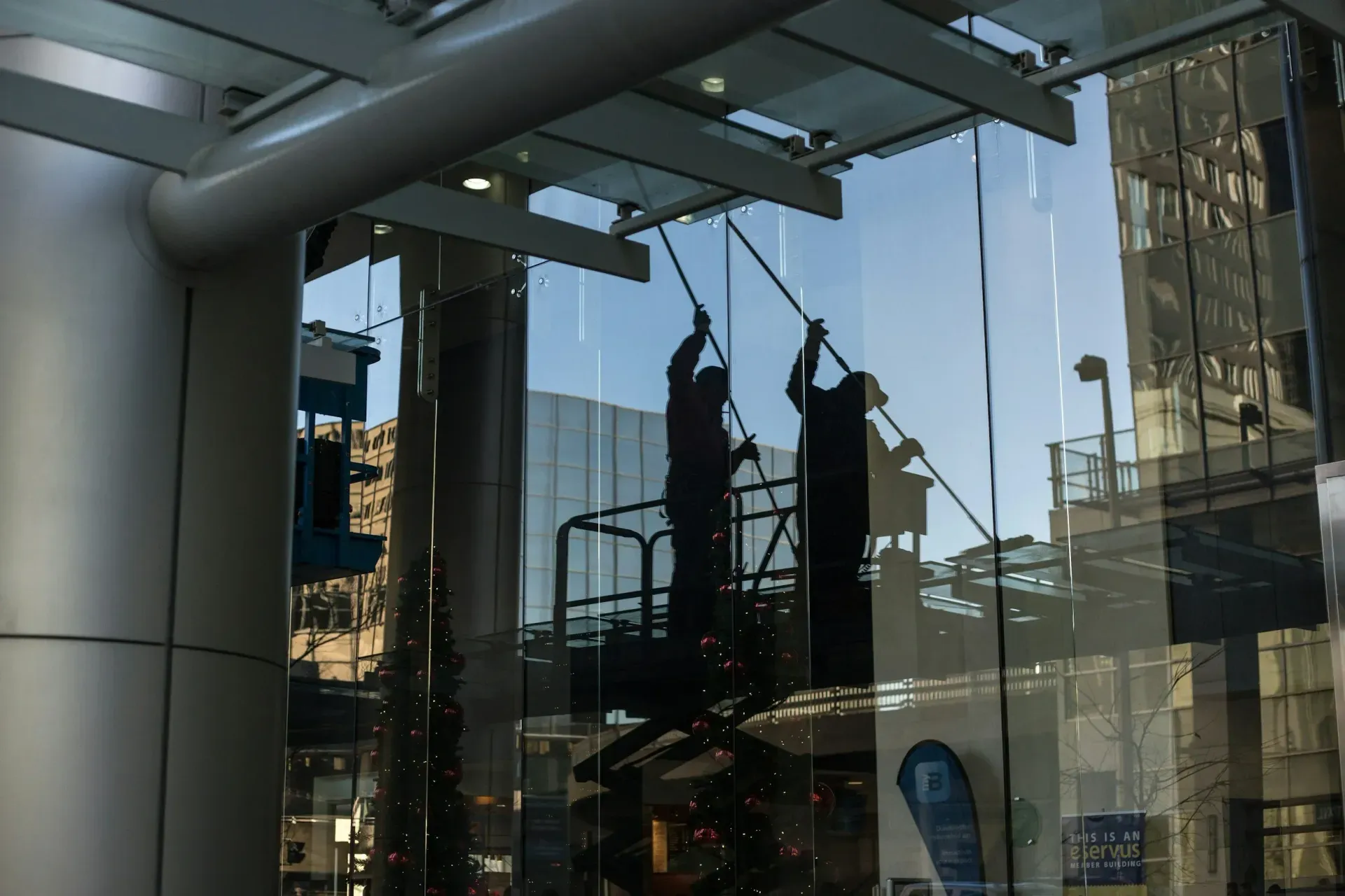 Window cleaners working on tall exterior glass